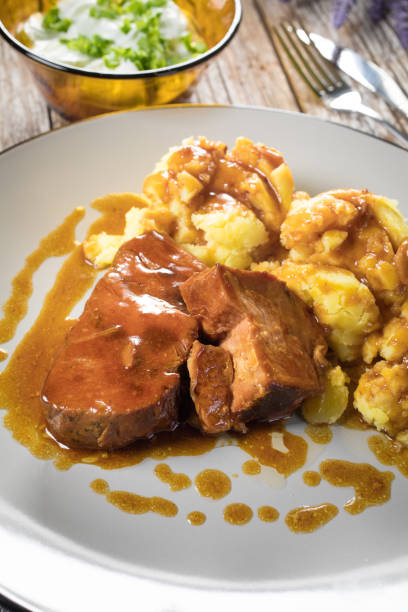 istock Braised pork neck in own sauce served with boiled potatoes. 1370355204