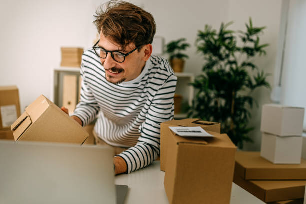 istock Male entrepreneur using laptop on desk in store 1370355225