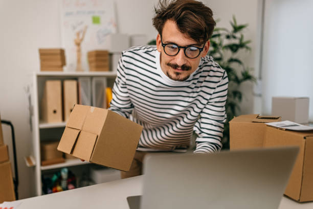 istock Male entrepreneur using laptop on desk in store 1370355238