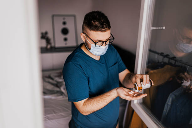 istock Portrait of young man taking a pill 1370356418