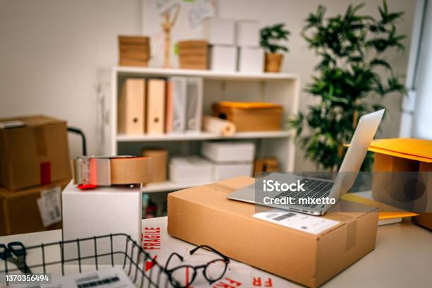 Closeup Of Laptop With Cardboard Box On Desk In Office Stock Photo - Download Image Now