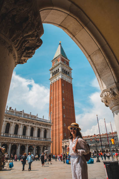 woman looking at bell tower of venice city summer time woman looking at bell tower of venice city summer time crowd of tourists campanile venice stock pictures, royalty-free photos & images