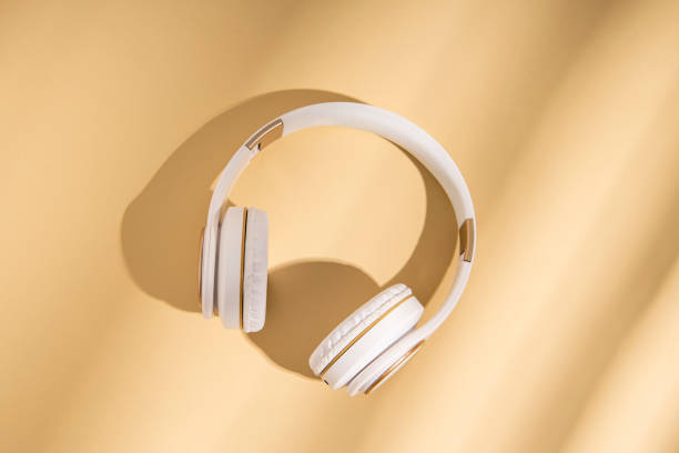 istock Wireless headphones on a beige background. Flat lay, top view. 1370357678