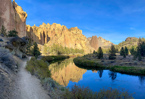 Beautiful reflection of the golden stone mountain in the Crooked River in Smith Rock State Park in Oregon