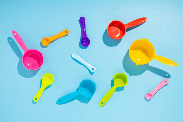 istock Multi-colored measuring spoons on a blue background. Flat lay, top view. 1370357766