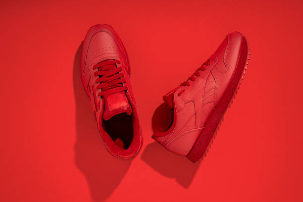 istock Clean red sneakers on a red background. Top view, flat lay. 1370357810