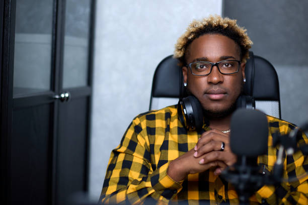 istock Black guy keeps his hands folded, sitting comfortably in a chair. 1370361159