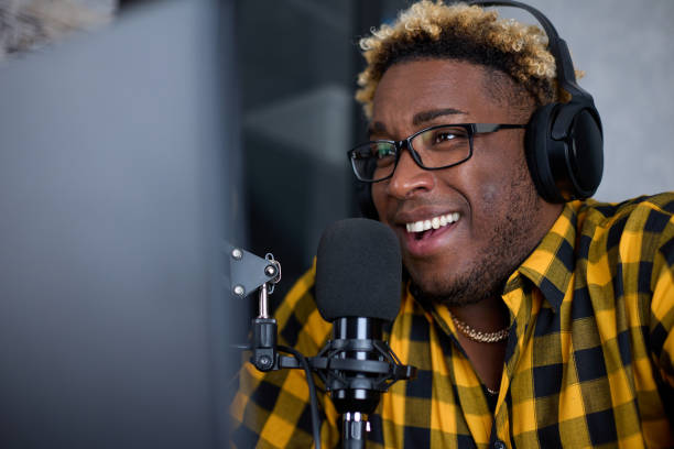 istock Positive man is a radio host with glasses, a podcast host or an interview 1370364095