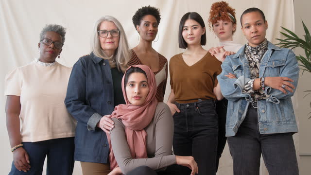 Slow motion of multi ethnic mixed age range women looking at camera for International Women's Day