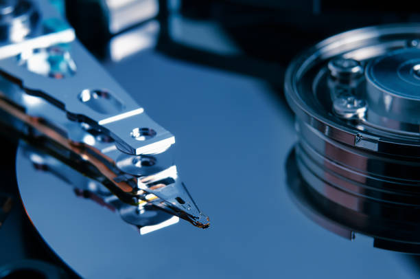 istock Open hard disk drive with magnetic head closeup. 1370366885