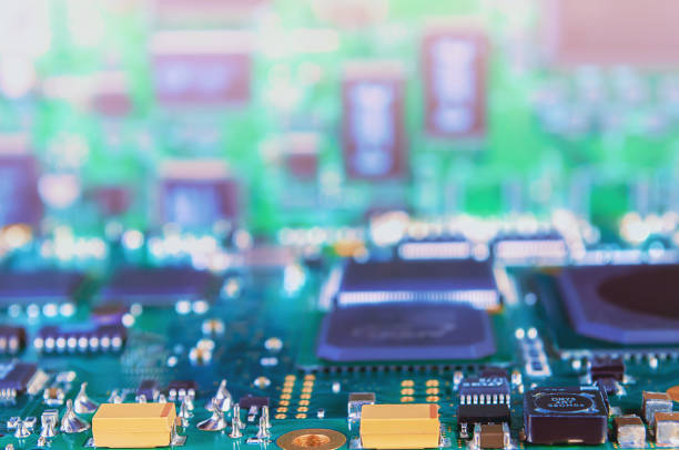 istock Closeup of Printed Circuit Board with processor, integrated circuits and many other surface mounted passive electrical components. 1370366886