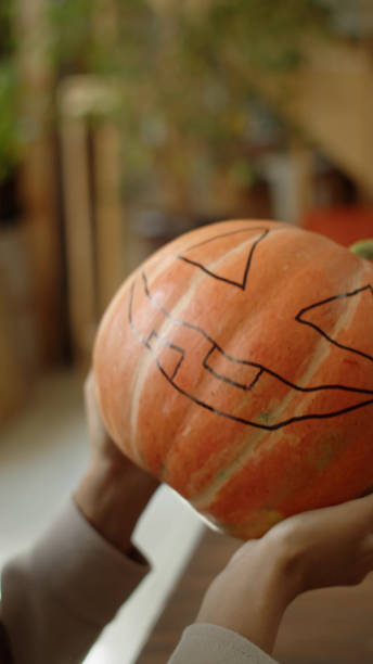 istock A young lady is holding a pumpkin and smiling 1370368331