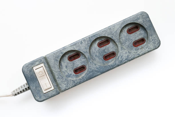 An old electrical power extension cable with european sockets on white background