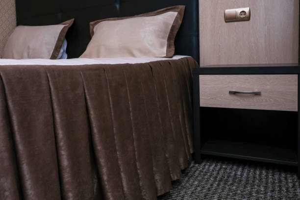 istock Big double classic style bed in a hotel room 1370371988