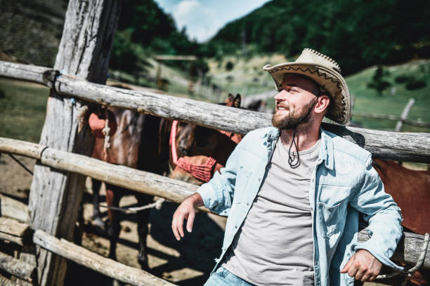 istock Relaxed Male Rancher Spending Sunny Day With Horses 1370373659