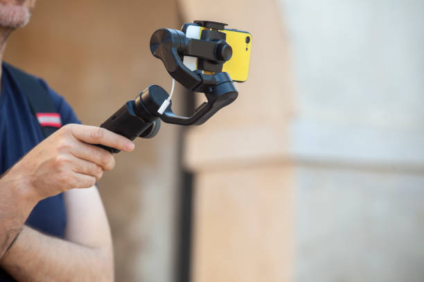istock Mature man recording with smartphone gimbal 1370374190