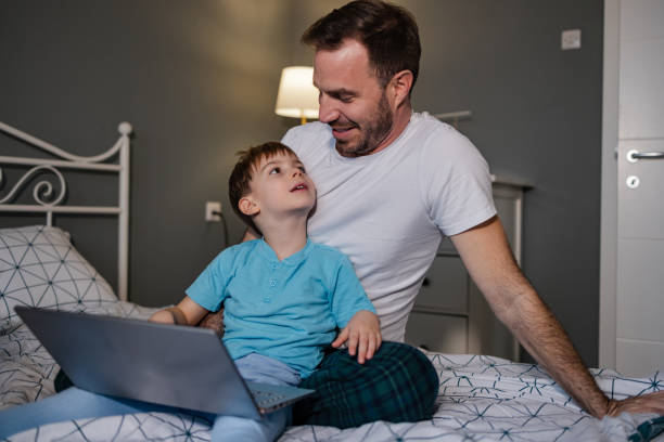 istock Father and son using laptop in the morning 1370374803