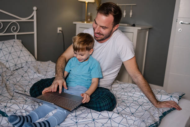 istock Father and son using laptop in the morning 1370374922