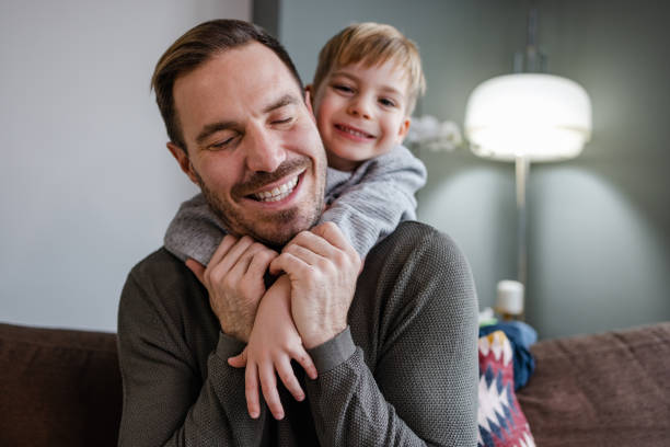 istock Portrait of a young boy hugging  his father 1370376155