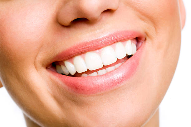 Smiling young woman with white teeth stock photo