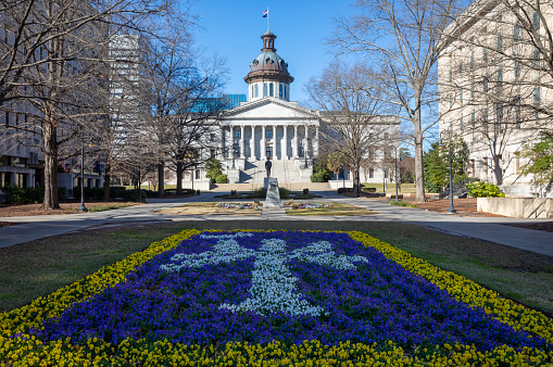 The South Carolina State House with the state flag flowerbed in the foreground.