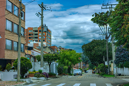 Bogota, Colombia - Drivers point of view in the residential district of Cedritos District of the Colombian Capital city of Bogota. The street is Calle 151 driving West. Overhead power cables are a common sight in the City. The altitude at street evel is 8,660 feet above mean sea level. Horizontal Format.