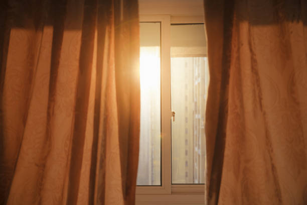 The early morning sun shone on the curtains