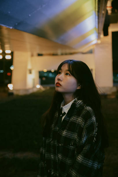 istock Young asian girls under neon lights at night 1370383652