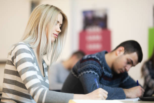 istock Young student in modern classroom listening to lecture. 1370385896