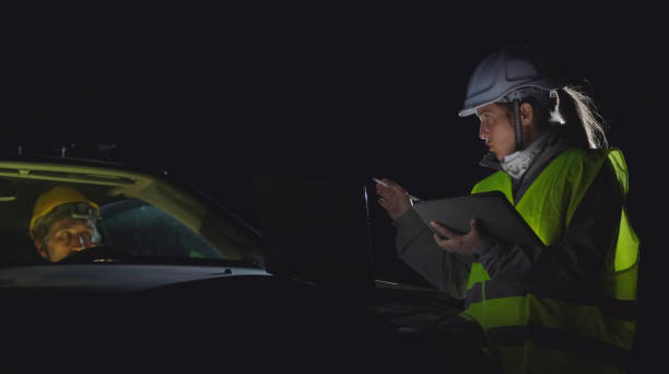 istock High voltage engineers working on the field at night. Sustainable energy. 1370390655