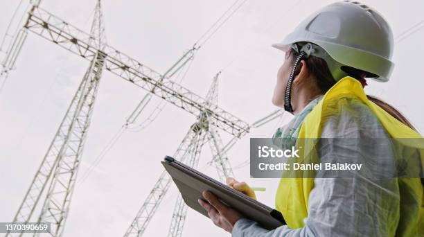 High Voltage Female Engineer Working On The Field Stock Photo - Download Image Now - Electricity Substation, Power Station, Carbon Neutrality