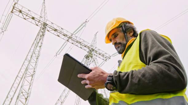 istock High voltage engineer working on the field at night. Sustainable energy. 1370390662