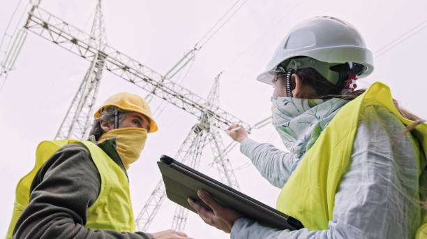 istock High voltage engineers working on the field in COVID-19. Teamwork. 1370390663
