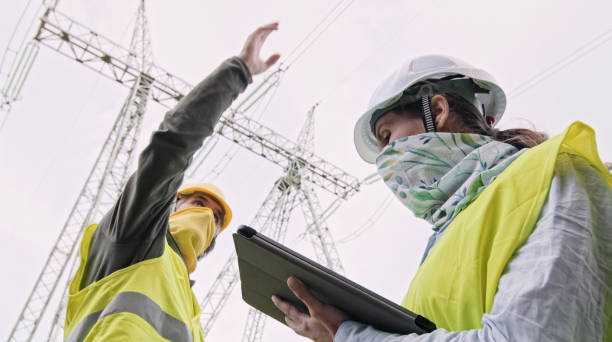 istock High voltage engineers working on the field in COVID-19. Teamwork. 1370390664