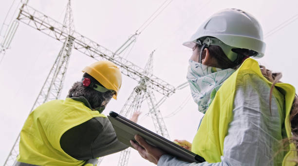 istock High voltage engineers working on the field in COVID-19. Teamwork. 1370390666