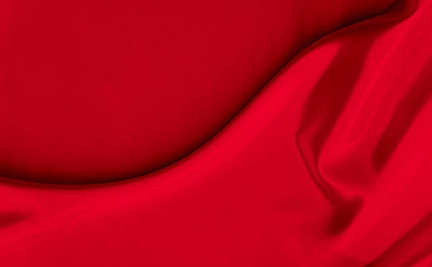 istock Black red satin dark fabric texture luxurious shiny that is abstract silk cloth background with patterns soft waves blur beautiful. 1370390874
