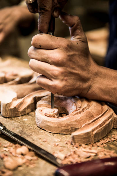 istock Closeup of a carpenter hands working with a chisel 1370391398
