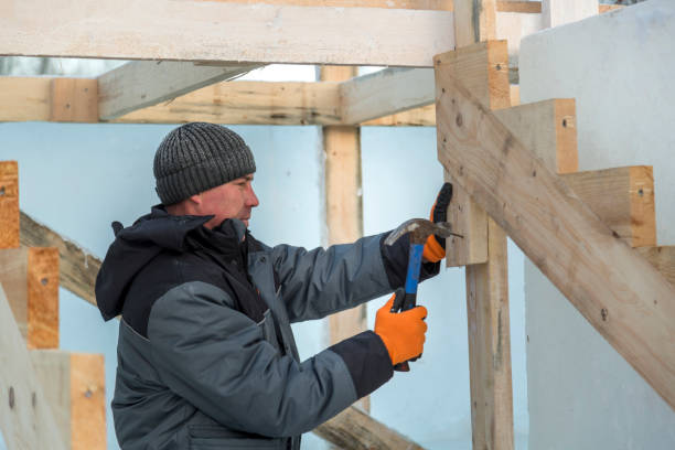 istock Worker assembling the frame of a wooden slide 1370395712