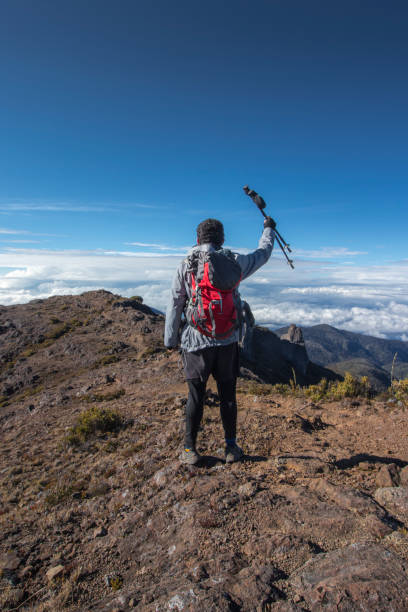 istock man from behind with his sticks up through rocky mountains with paramo vegetation in Chirripo National Park 1370402182