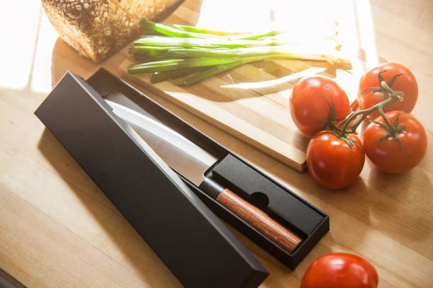 istock Solid Steel professional chef knife on wooden counter cutting board with freshly chopped fruits, vegetables, meet, and bread 1370408866