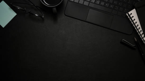 istock Black workspace top view, copy space on black leather background. flat lay 1370409883