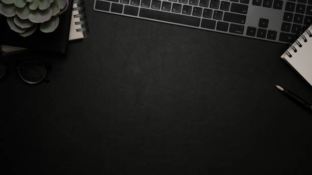 istock Top view, Modern office table with keyboard and copy space on black background. 1370409888