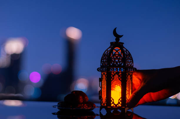 istock Lantern that have moon symbol on top and small plate of dates fruit 1370413969