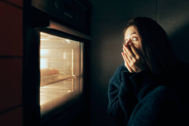 istock Surprised Woman Looking in the Oven Feeling Hungry 1370414746