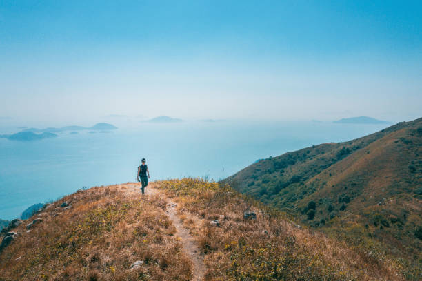 istock backpacker hiker walking on mountain nearby the sea 1370418667