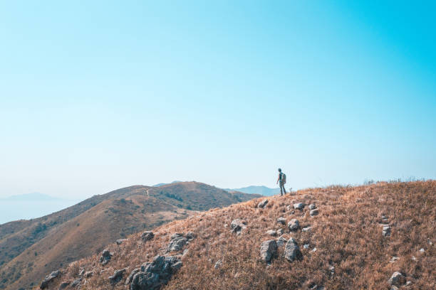 istock single backpack hiker standing on highland of a mountain 1370418668