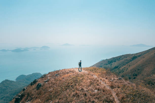 istock backpacker hiker walking on mountain nearby the sea 1370418671
