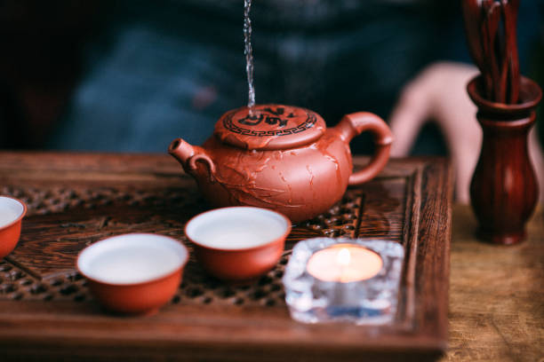 Tea master pouring water on teapot. Tea ceremony concept stock photo