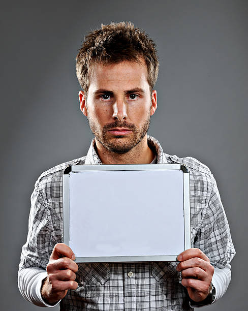 istock Serious young man holding sign 137041910