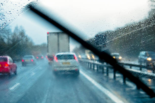 Adverse Driving Conditions Rain through the window of a car on a motorway truck rain stock pictures, royalty-free photos & images